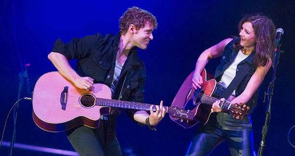 Justin and Sarah playing guitar in color